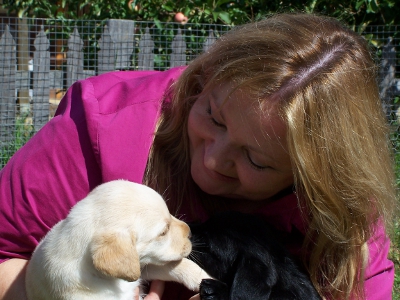 Alison holding two pups